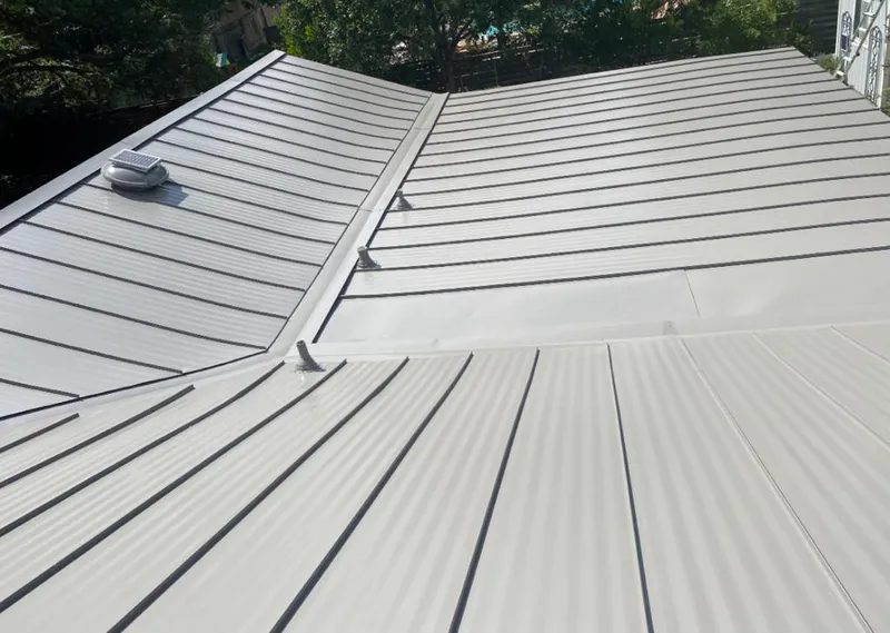Solar attic fan installed on a metal roof for Roof Ventilation in Myrtle Grove